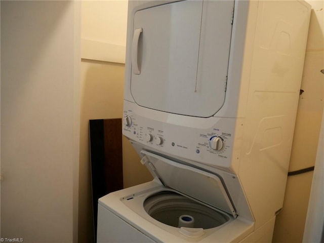 clothes washing area featuring stacked washer / drying machine