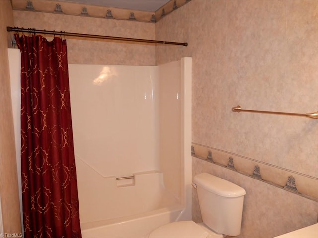 bathroom with shower / bath combination with curtain and toilet