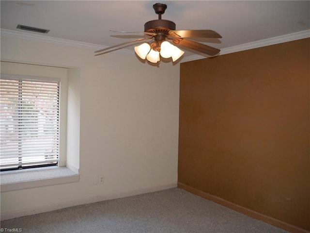 spare room featuring crown molding, carpet floors, and ceiling fan