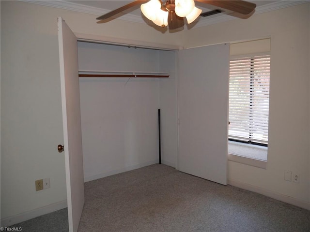 unfurnished bedroom featuring ornamental molding, carpet flooring, a closet, and ceiling fan