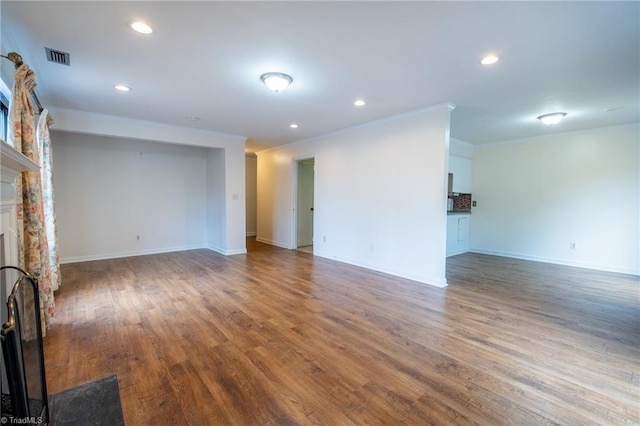 unfurnished living room with a fireplace, ornamental molding, recessed lighting, wood finished floors, and baseboards