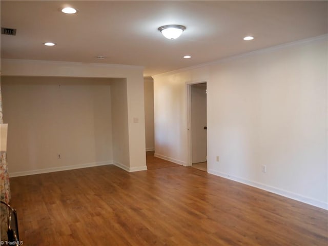 basement with ornamental molding and hardwood / wood-style floors