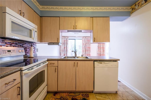 kitchen featuring white appliances, a sink, light brown cabinets, baseboards, and light tile patterned floors