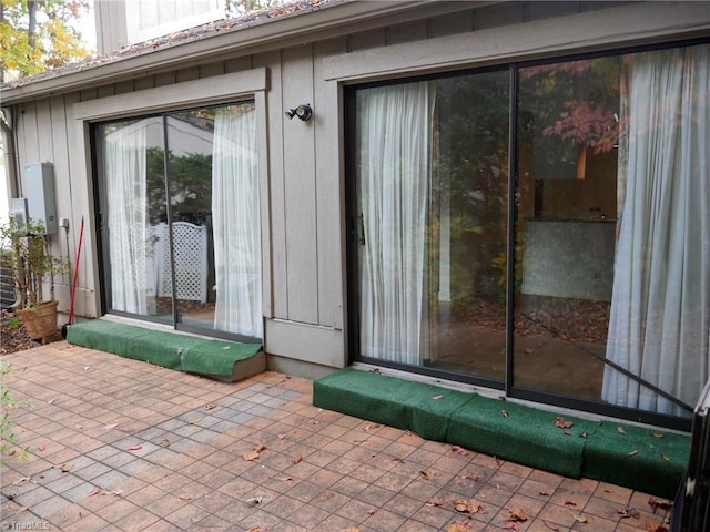 view of exterior entry featuring a patio