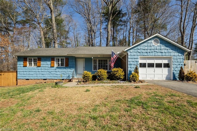 ranch-style home with aphalt driveway, an attached garage, a front lawn, and fence