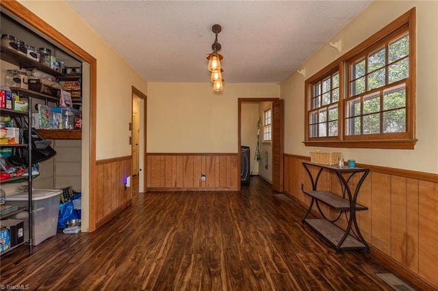 dining area with visible vents, wainscoting, wood walls, and wood finished floors