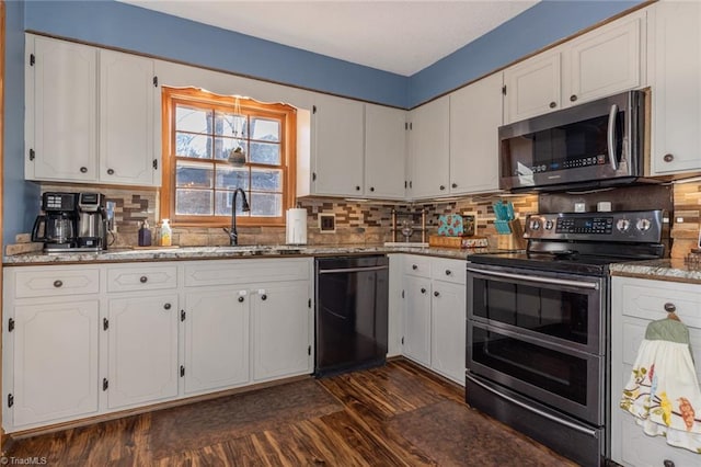 kitchen featuring a sink, stainless steel appliances, dark wood-style flooring, and white cabinetry