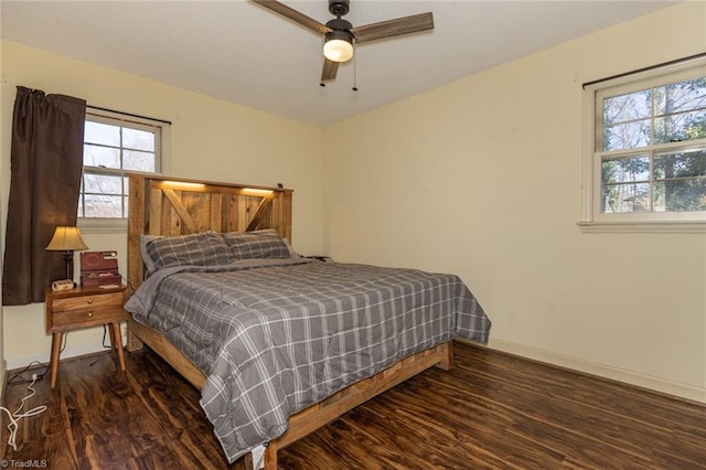 bedroom featuring ceiling fan, baseboards, and wood finished floors