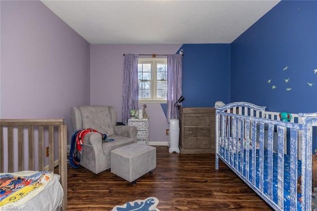 bedroom featuring baseboards and wood finished floors