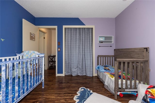 bedroom featuring wood finished floors, a closet, and baseboards