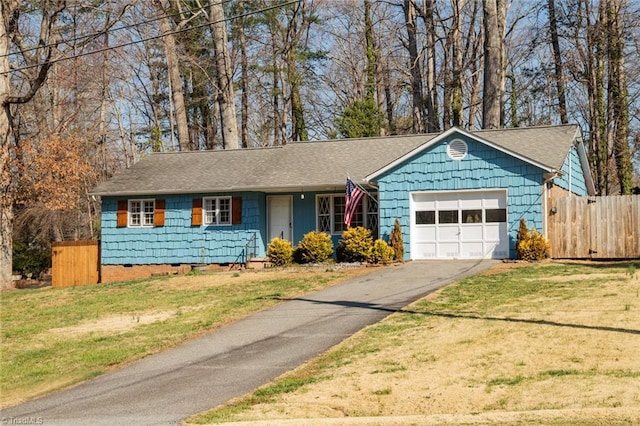 ranch-style home featuring aphalt driveway, a front lawn, a garage, and fence