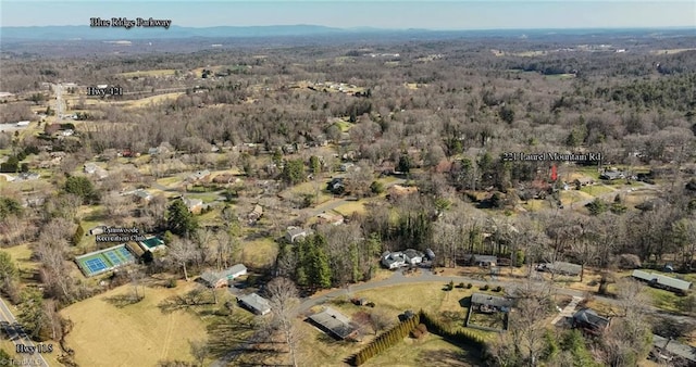 drone / aerial view with a wooded view