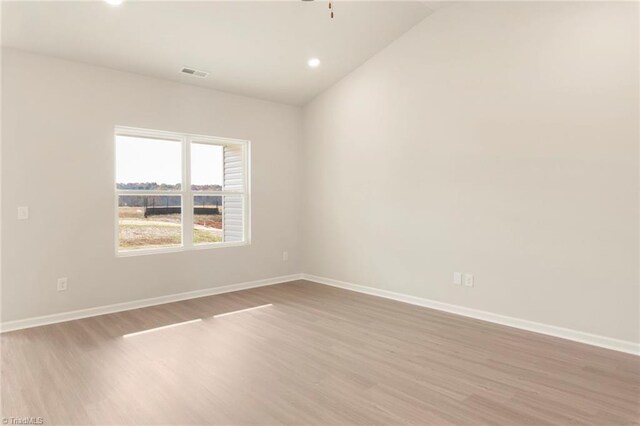 spare room featuring light wood-type flooring, recessed lighting, baseboards, and visible vents