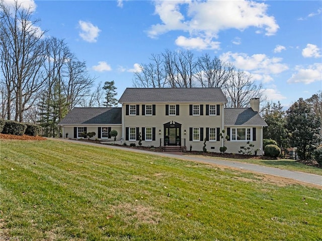 colonial inspired home with a front yard