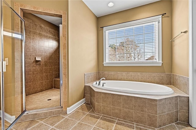 bathroom featuring tile patterned flooring, a shower stall, and a bath