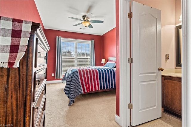 bedroom featuring light carpet, a ceiling fan, visible vents, and baseboards