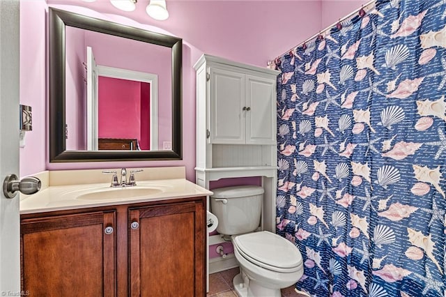 bathroom featuring a shower with shower curtain, vanity, toilet, and tile patterned floors