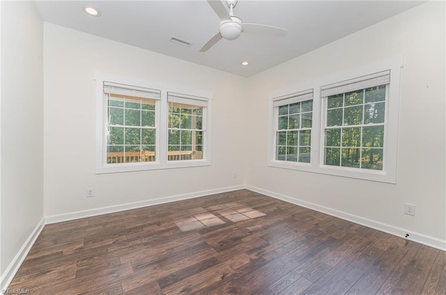 spare room with dark wood-type flooring and ceiling fan