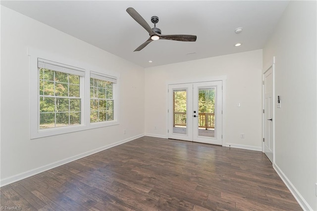 empty room featuring french doors, ceiling fan, and dark hardwood / wood-style flooring