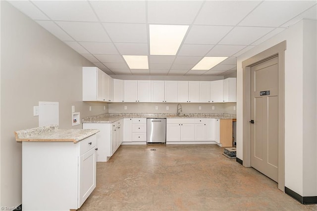 kitchen featuring sink, light stone countertops, stainless steel dishwasher, white cabinets, and a paneled ceiling