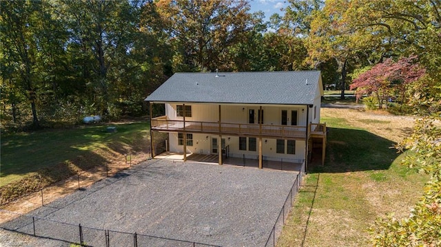 rear view of property featuring a yard