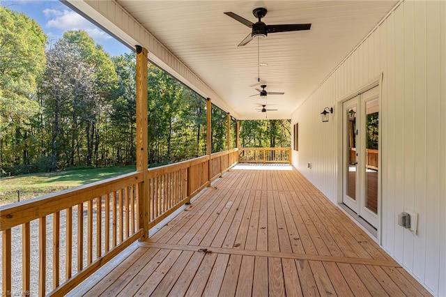 deck with french doors, a yard, and ceiling fan