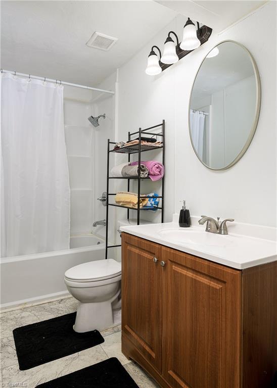 1519 Graves Ave, High Point, NC 27260 - bathroom with vanity, toilet, and shower / tub combo