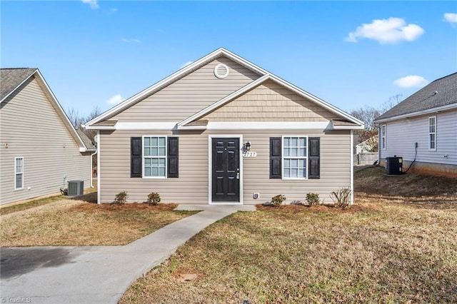 bungalow featuring central AC and a front yard