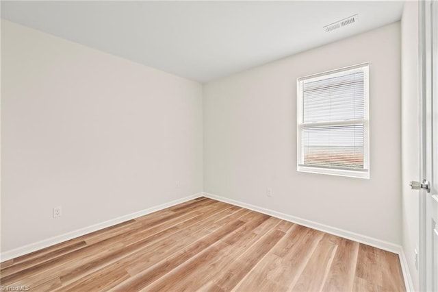 spare room featuring light hardwood / wood-style floors