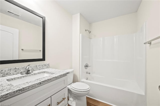 full bathroom featuring toilet, vanity, wood-type flooring, and shower / bathing tub combination