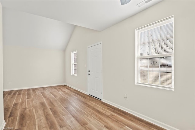 interior space with light wood-type flooring and lofted ceiling