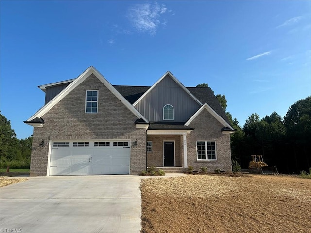 craftsman-style home with concrete driveway, brick siding, and a garage