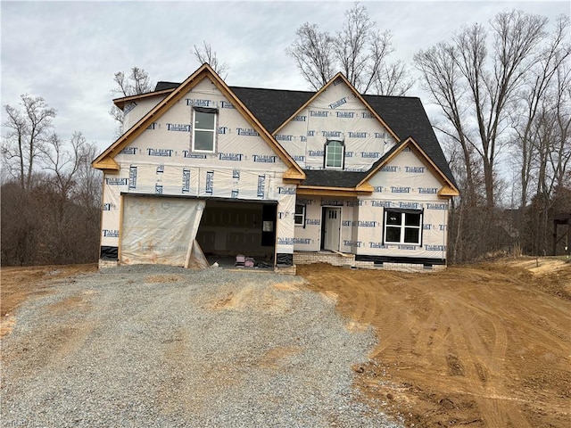 property under construction featuring gravel driveway