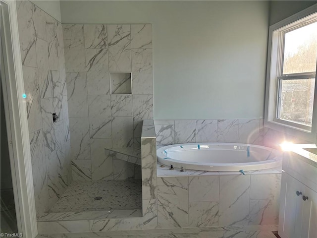 bathroom featuring a marble finish shower, a bath, and vanity