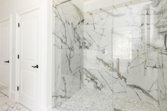 full bathroom with a marble finish shower and marble finish floor