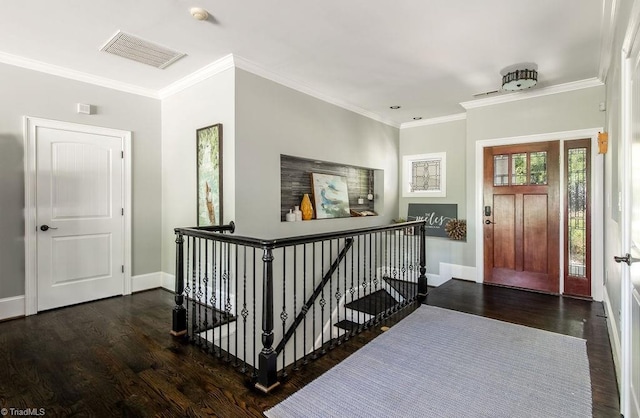 entryway with baseboards, visible vents, and wood finished floors