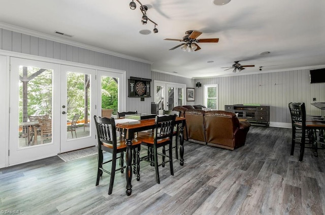 dining space with a healthy amount of sunlight, ornamental molding, and french doors