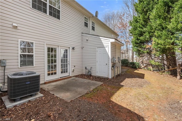 rear view of house with a patio and central AC unit