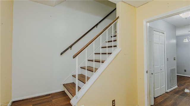 stairs featuring hardwood / wood-style flooring