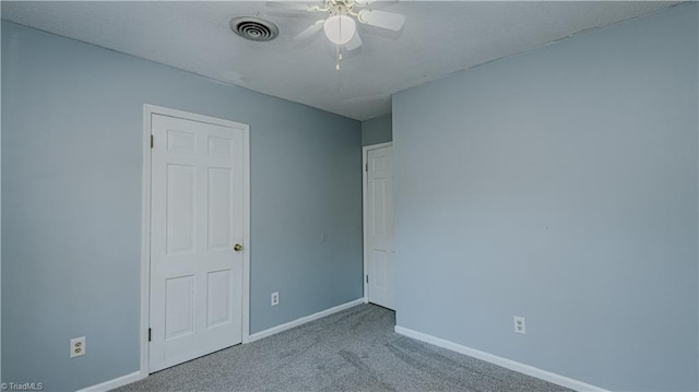 empty room with light colored carpet and ceiling fan