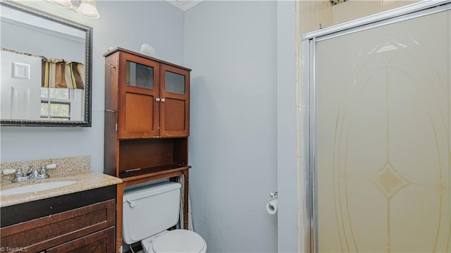 bathroom featuring vanity, toilet, and walk in shower