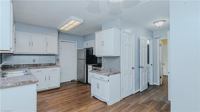 kitchen featuring sink, white cabinetry, backsplash, and dark hardwood / wood-style flooring