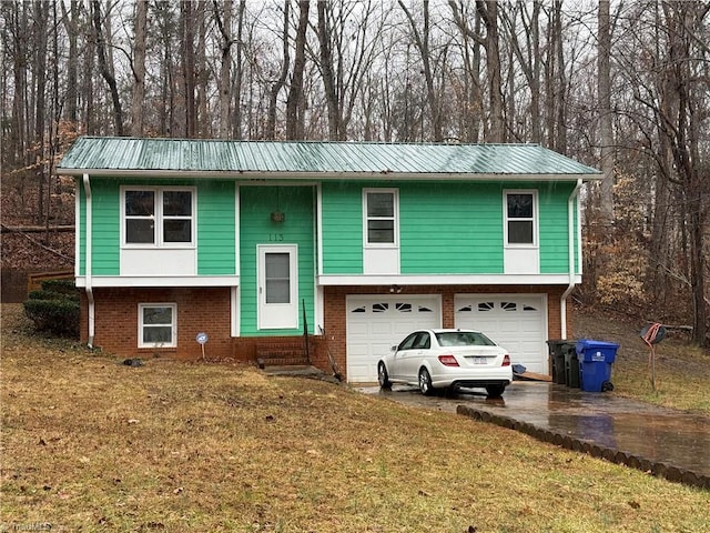 bi-level home with a garage and a front yard