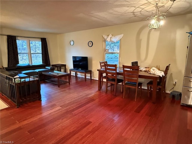 dining space with wood-type flooring and a chandelier