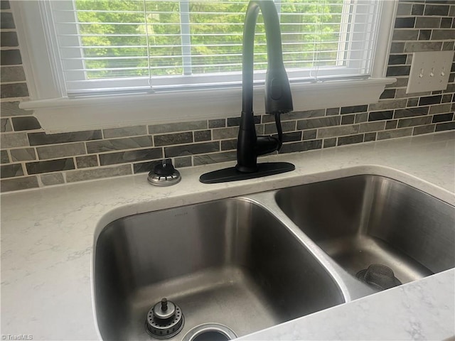258 S Boyles St, Pilot Mountain, NC 27041 - kitchen view of a sink, decorative backsplash, and light stone countertops