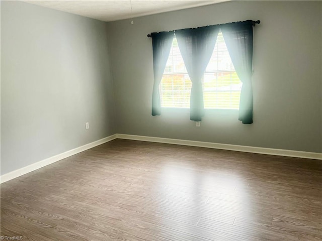 258 S Boyles St, Pilot Mountain, NC 27041 - empty room featuring wood finished floors and baseboards