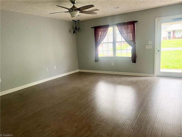 258 S Boyles St, Pilot Mountain, NC 27041 - spare room featuring a textured ceiling, a ceiling fan, dark wood-style flooring, and baseboards