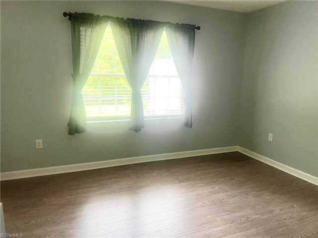 258 S Boyles St, Pilot Mountain, NC 27041 - spare room featuring wood finished floors and baseboards