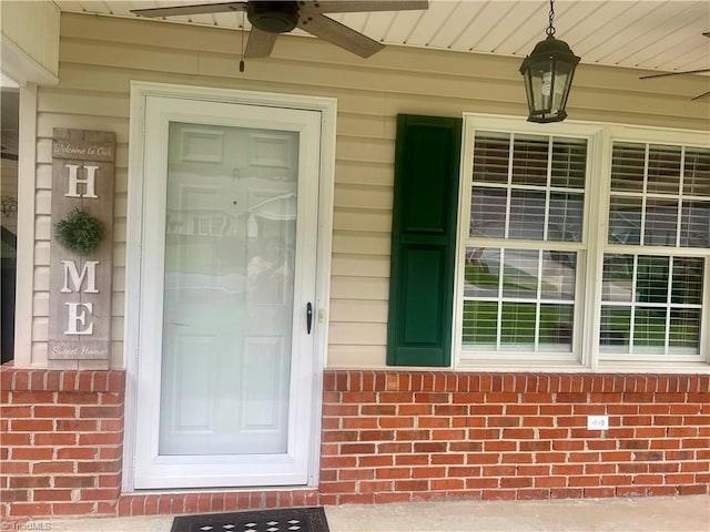 258 S Boyles St, Pilot Mountain, NC 27041 - doorway to property featuring a ceiling fan, brick siding, and covered porch