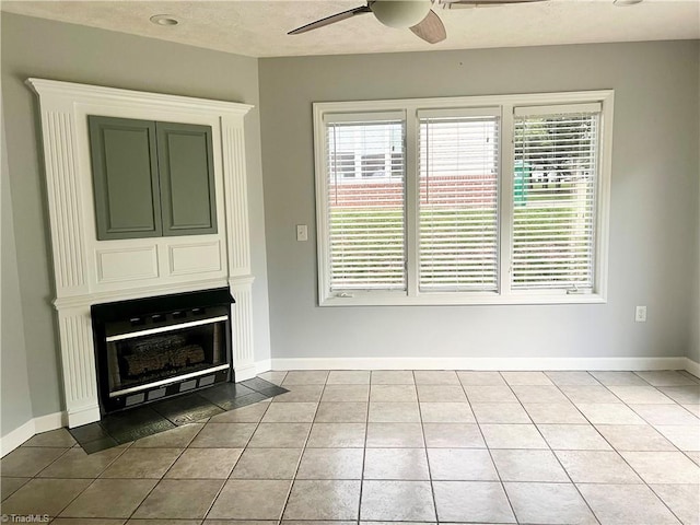 258 S Boyles St, Pilot Mountain, NC 27041 - unfurnished living room with a ceiling fan, plenty of natural light, tile patterned floors, and baseboards